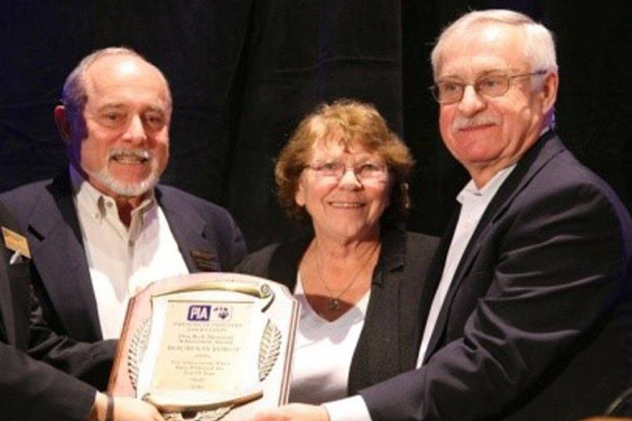 Three people from Bourdon Forge company accepting an award.