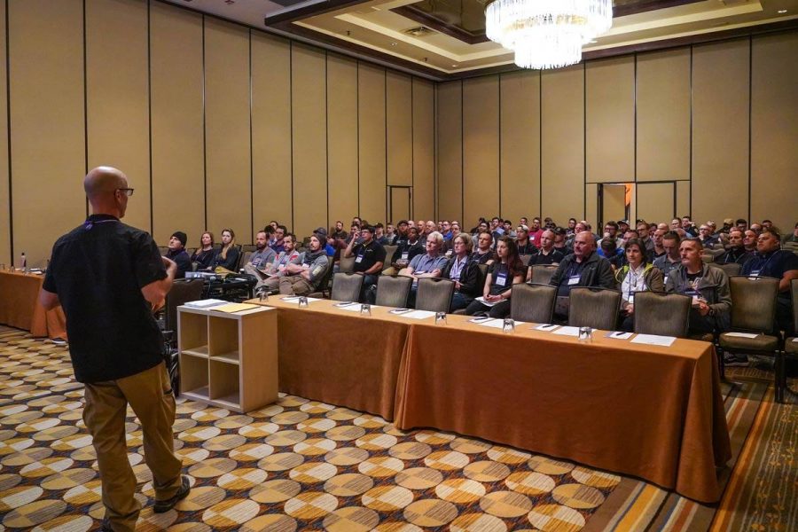 Crowd of people enjoying a seminar at the PIA Symposium.